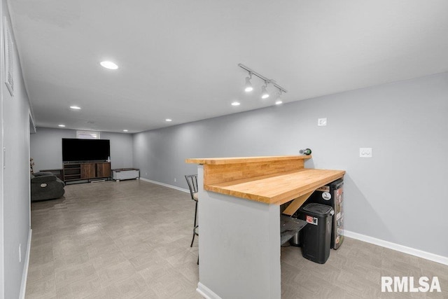 dining room with baseboards, a bar, recessed lighting, and tile patterned floors