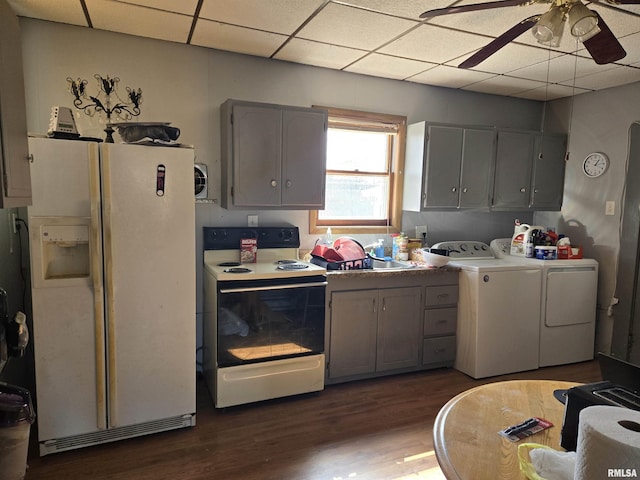 kitchen with electric stove, wood finished floors, washing machine and clothes dryer, a paneled ceiling, and white fridge with ice dispenser