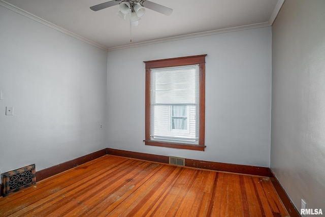 empty room featuring hardwood / wood-style flooring, baseboards, and visible vents