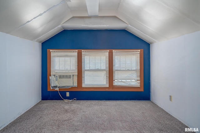 unfurnished room featuring lofted ceiling, cooling unit, and carpet flooring