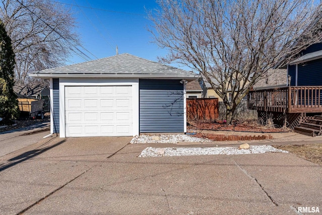 detached garage with driveway and fence