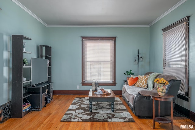 living room with plenty of natural light, crown molding, and wood finished floors