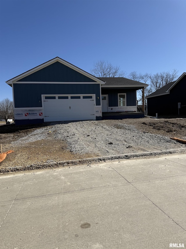 view of front of house with driveway, board and batten siding, and an attached garage