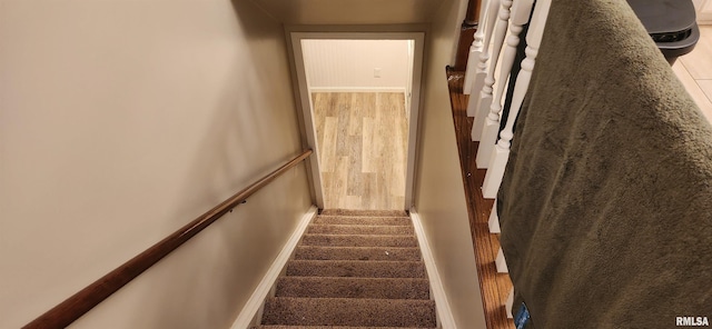 stairs with baseboards and wood finished floors