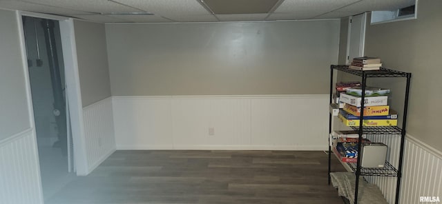 spare room with a paneled ceiling, wainscoting, and wood finished floors