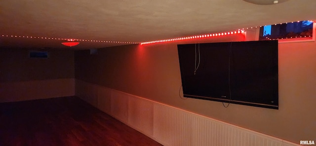 interior space featuring a wainscoted wall and wood finished floors