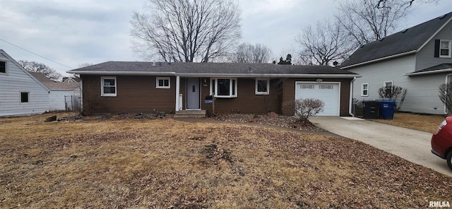 ranch-style house with concrete driveway and an attached garage