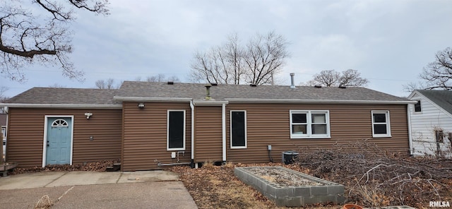 back of property featuring a vegetable garden