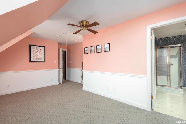 spare room featuring attic access, ceiling fan, and baseboards