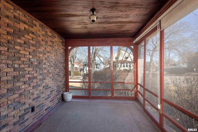 unfurnished sunroom featuring wooden ceiling