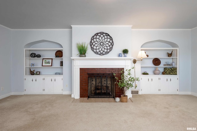 carpeted living room featuring a brick fireplace, baseboards, built in features, and ornamental molding