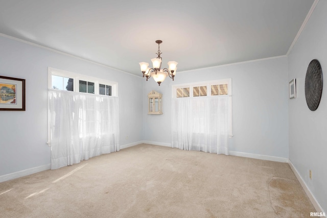 carpeted empty room featuring ornamental molding, a notable chandelier, and baseboards