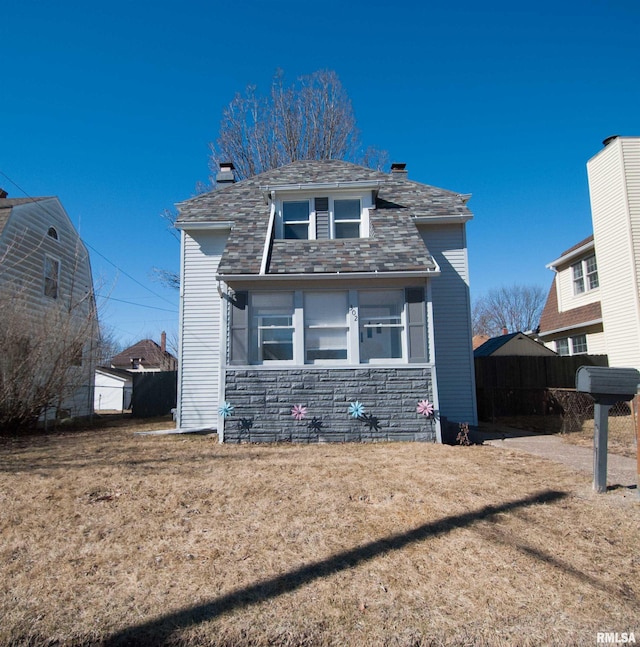 view of front of property featuring stone siding and a chimney