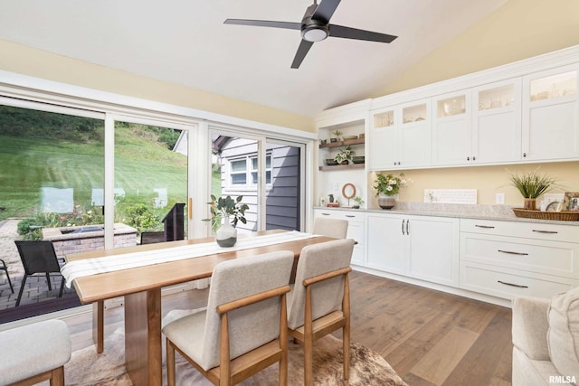 dining space featuring light wood-type flooring, ceiling fan, and lofted ceiling