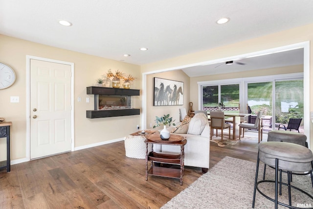 living area featuring dark wood-style floors, recessed lighting, and baseboards