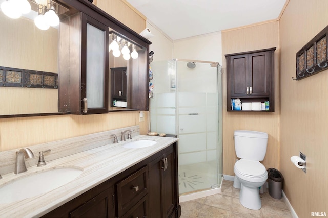 bathroom with double vanity, a sink, toilet, and a shower stall