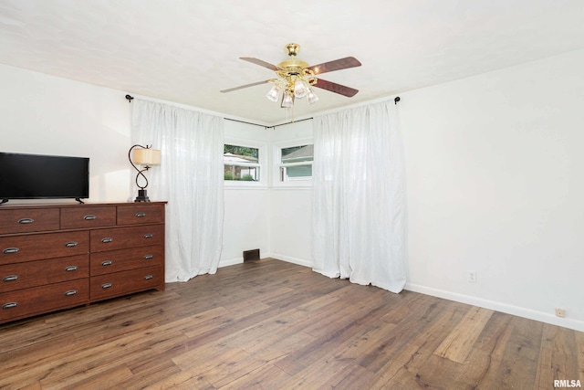 bedroom with ceiling fan, baseboards, and wood finished floors