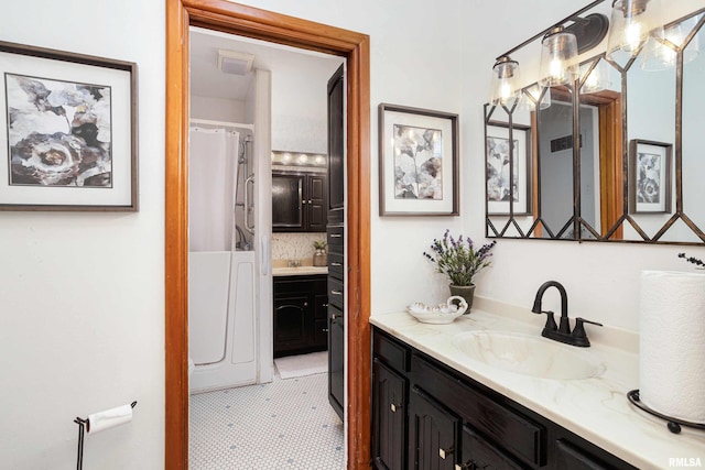 clothes washing area featuring cabinet space and washer and clothes dryer