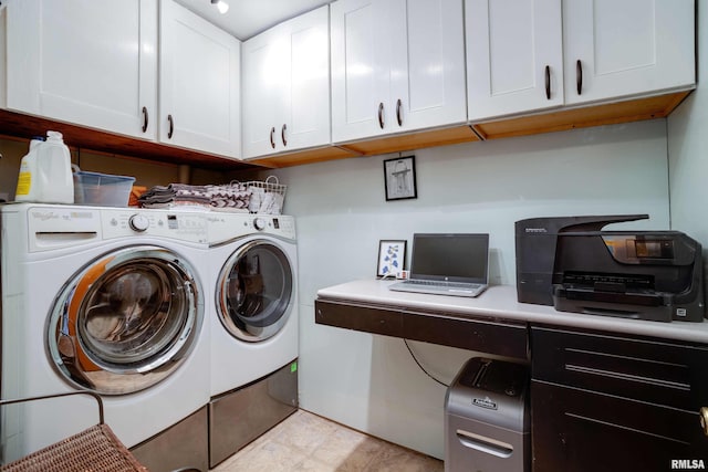 clothes washing area featuring washing machine and dryer and cabinet space