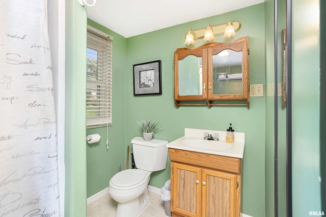 full bath featuring toilet, a shower with shower curtain, vanity, baseboards, and tile patterned floors