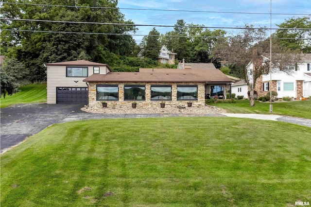 view of front of property with a garage, stone siding, a front lawn, and aphalt driveway