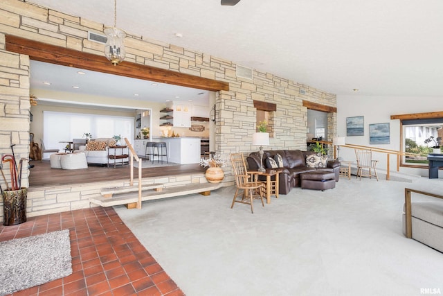 tiled living area with lofted ceiling and visible vents