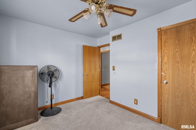 unfurnished bedroom with a ceiling fan, baseboards, visible vents, and carpet flooring