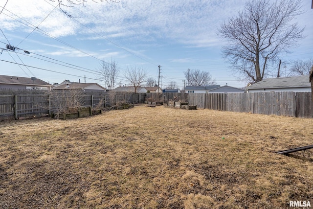 view of yard featuring a fenced backyard and a vegetable garden