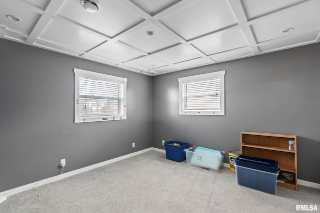 empty room featuring baseboards, coffered ceiling, and carpet flooring