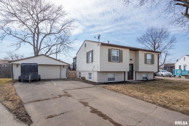 view of front of house with a front yard, an outdoor structure, a detached garage, and fence