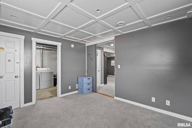 unfurnished bedroom with connected bathroom, coffered ceiling, carpet flooring, washer and dryer, and baseboards