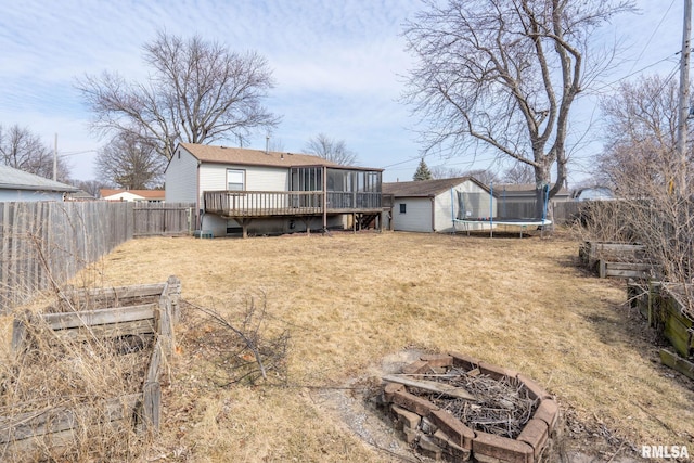 back of property with a vegetable garden, a lawn, a trampoline, an outdoor structure, and a shed