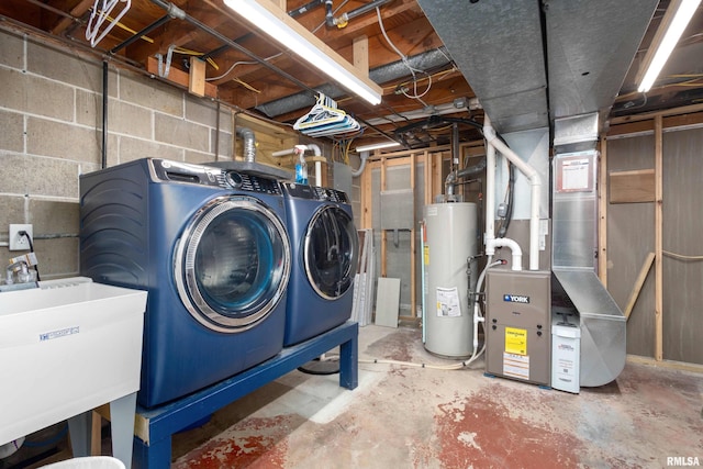 unfinished basement featuring washer and clothes dryer, gas water heater, and a sink