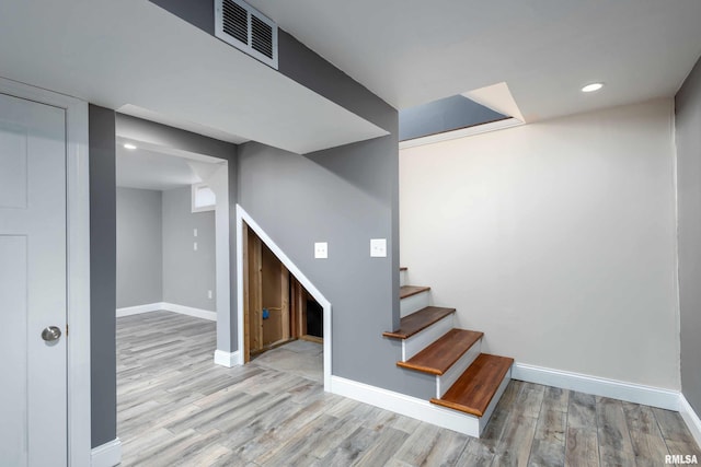 staircase featuring recessed lighting, wood finished floors, visible vents, and baseboards