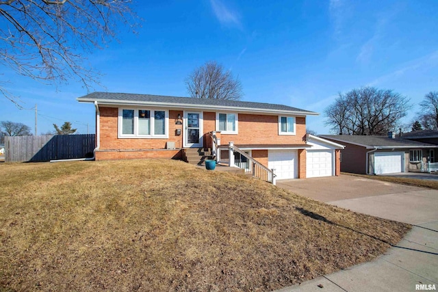 ranch-style home with brick siding, an attached garage, a front yard, fence, and driveway