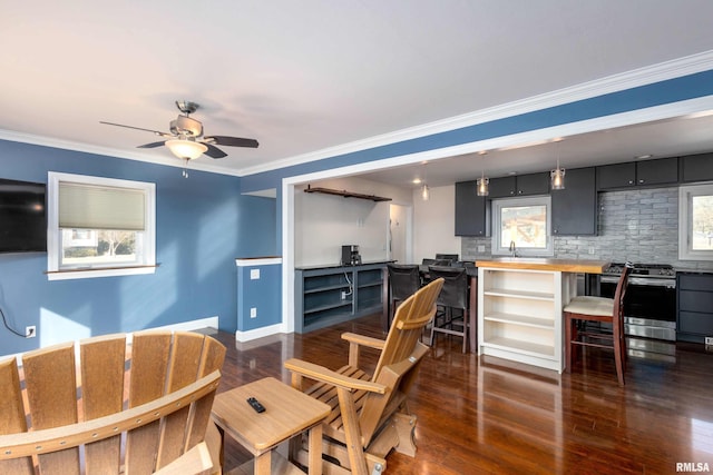 living room with dark wood-style floors, ceiling fan, and crown molding