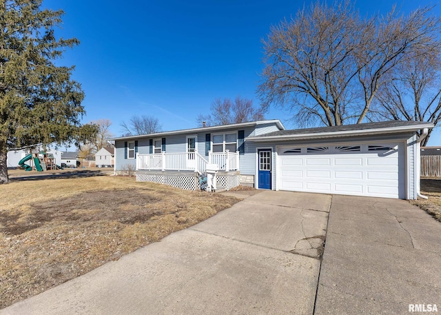 view of front of home with a front lawn, a playground, covered porch, concrete driveway, and a garage