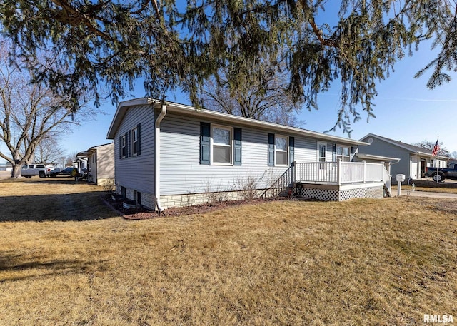 view of front of home with a deck and a front yard