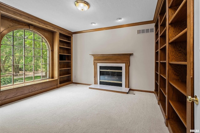 2 S Shore Ln, Rapids City, IL 61278 - unfurnished living room with carpet flooring, ornamental molding, built in shelves, and a glass covered fireplace