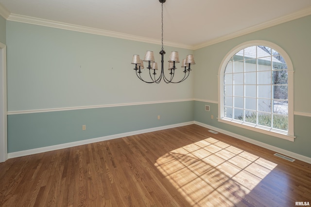 unfurnished dining area featuring a chandelier, a wealth of natural light, wood finished floors, and visible vents