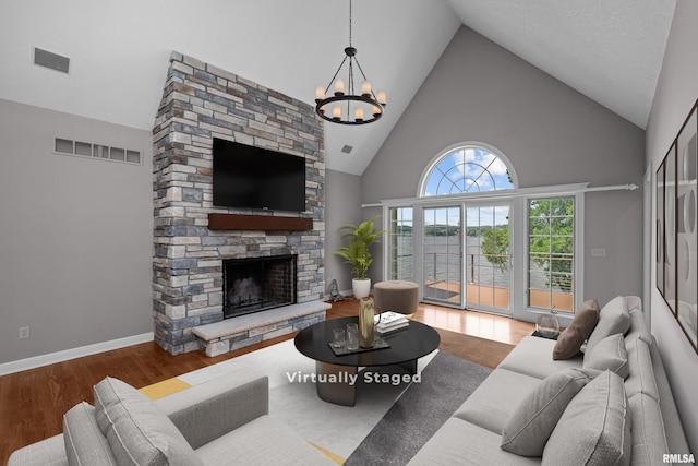 2 S Shore Ln, Rapids City, IL 61278 - living room featuring high vaulted ceiling, a fireplace, a chandelier, and wood finished floors