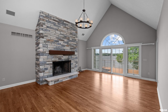 2 S Shore Ln, Rapids City, IL 61278 - unfurnished living room with high vaulted ceiling, a chandelier, a fireplace, and wood finished floors