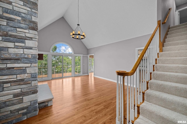 2 S Shore Ln, Rapids City, IL 61278 - stairway featuring high vaulted ceiling, a chandelier, and wood finished floors