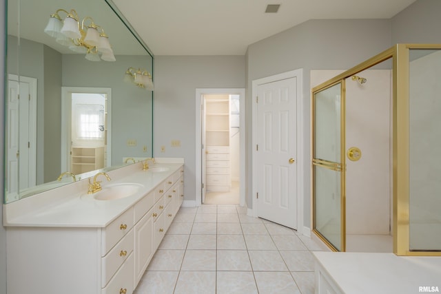 full bathroom with a stall shower, a closet, a sink, and tile patterned floors