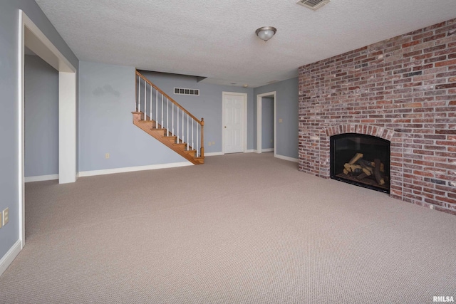 unfurnished living room with baseboards, stairs, visible vents, and a fireplace