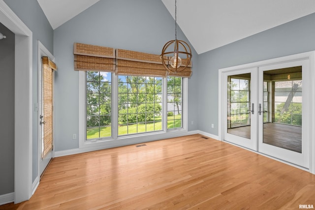 2 S Shore Ln, Rapids City, IL 61278 - unfurnished dining area with a chandelier, french doors, wood finished floors, plenty of natural light, and high vaulted ceiling