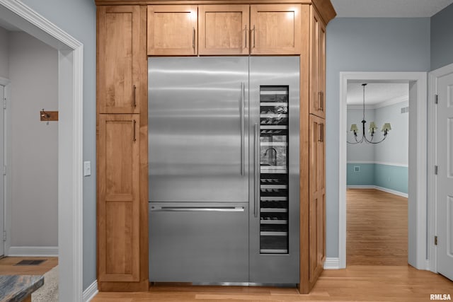2 S Shore Ln, Rapids City, IL 61278 - kitchen featuring high quality fridge, a chandelier, light wood-type flooring, and crown molding