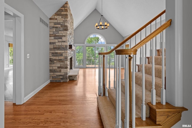 2 S Shore Ln, Rapids City, IL 61278 - entryway featuring wood finished floors, healthy amount of natural light, lofted ceiling, a chandelier, and stairs