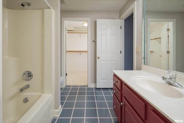 full bathroom with toilet, baseboards,  shower combination, and vanity