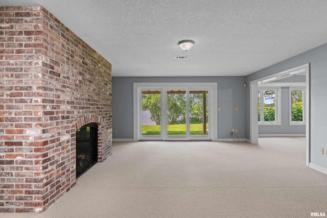 2 S Shore Ln, Rapids City, IL 61278 - unfurnished living room with carpet flooring, healthy amount of natural light, a brick fireplace, and a textured ceiling